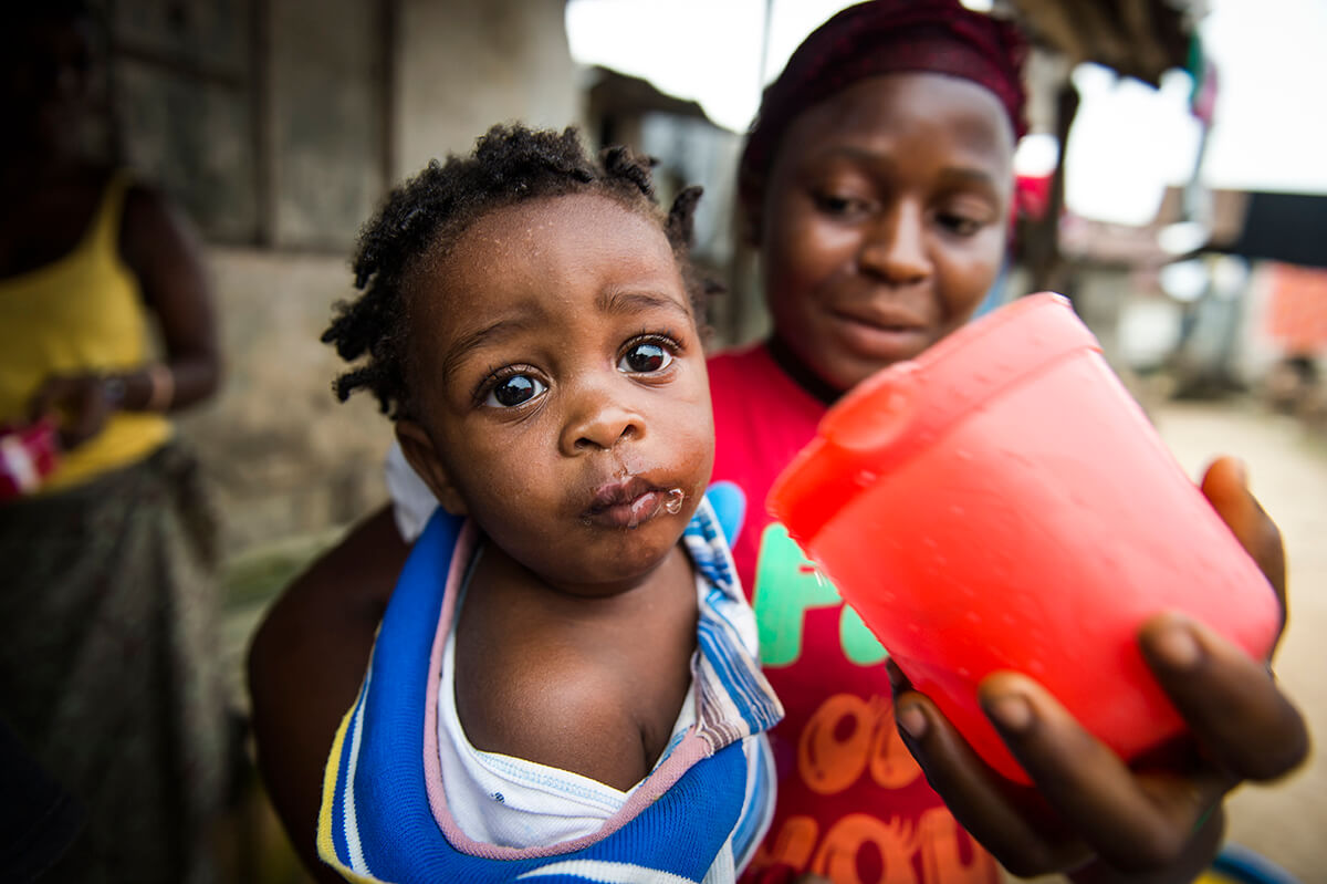 Child drinking water, Water Mission Liberia