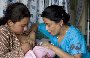 Midwife and mother holding newborn